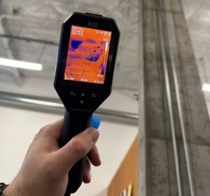 Professional using a thermal imaging camera to detect hidden moisture before mold remediation in an Everett home